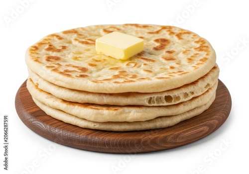 Stack of three whole grain pancakes with butter on top