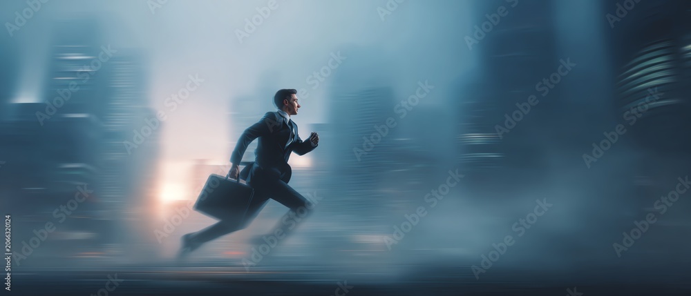 Fototapeta premium Businessman running through a misty cityscape.