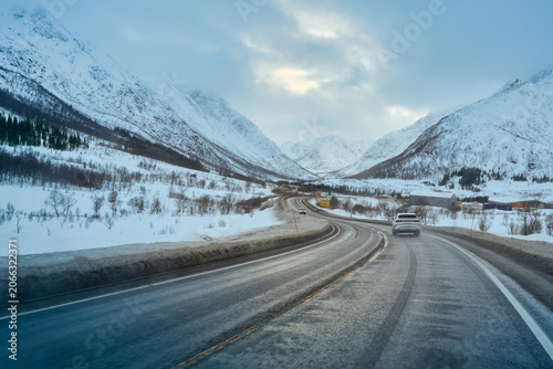 Epic Winter Lofoten Road Trip: Driving a White SUV Through Snow-Covered Mountain Valley in Arctic Norway, POV Scenic Journey.