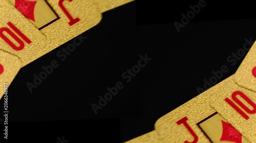 Gold Playing Cards in Motion on a Rotating Table