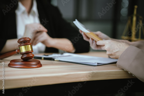 Photos Close-up of a legal consultation involving a contract and cash payment, illustrating financial settlement, legal services, business negotiation, and compliance discussions
