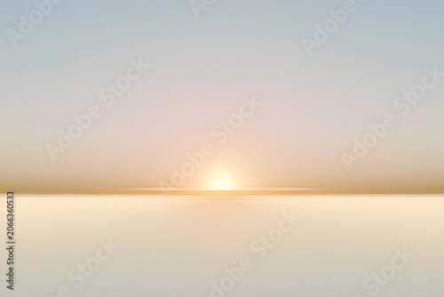 Serene sunrise over calm ocean horizon with clear sky