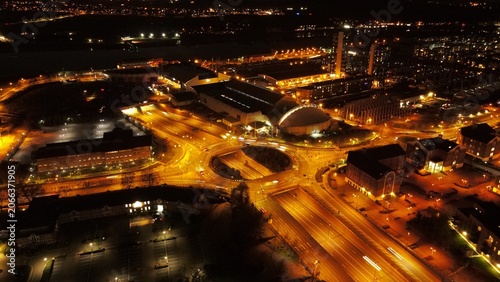Aerial view of a brightly lit roundabout and surrounding urban infrastructure at night in Chatham, England, United Kingdom.