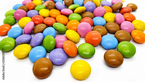 Colorful Candy Coated Chocolate Dragees Scattered on White Background