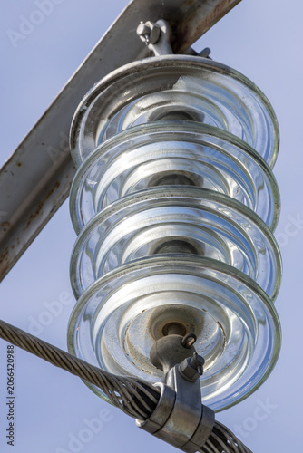Obraz na płótnie High voltage glass insulator suspends electrical transmission line cable against