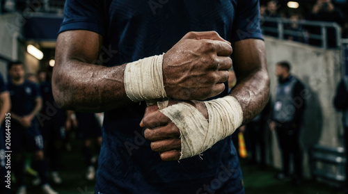 Athlete's Muscular Hands with Hand Wraps Before Competition