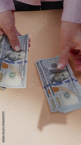 An unrecognizable woman counts American dollar bills close-up.