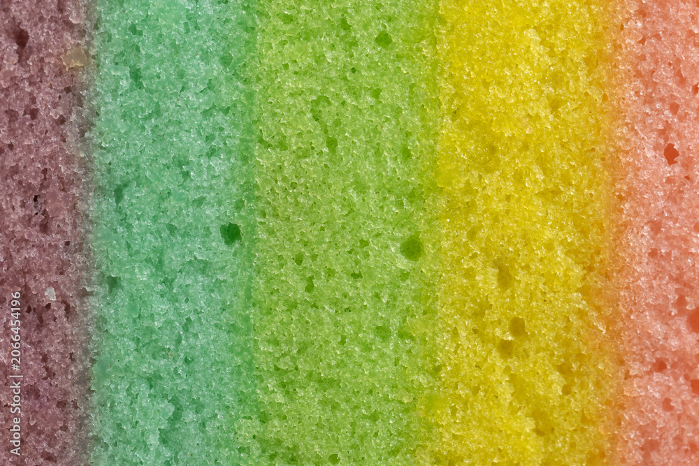 Fototapeta premium Close-up texture of a colorful layered rainbow cake sponge