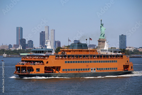 Staten Island Ferry sailing in New York Harbor with the Statue of Liberty in the background