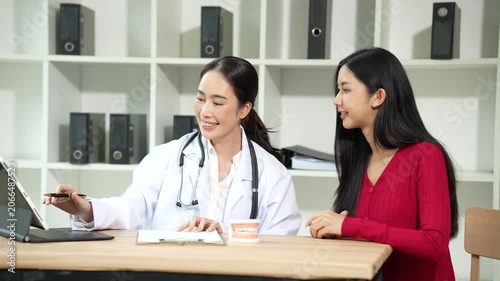 Professional dentist consulting with a patient in a modern dental clinic, explaining teeth restoration, prosthetic options, oral health care, treatment plans, and dental hygiene during a routine check