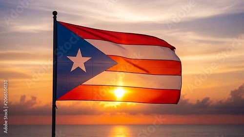 The flag of Puerto Rico waving against a beautiful tropical sunset over the ocean