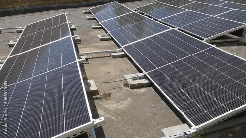 The Concept of Green Energy in an Urban Environment. Solar panels on the roofs of old apartment buildings. A rooftop solar power plant.
