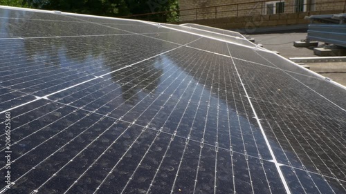 The Concept of Green Energy in an Urban Environment. Solar panels on the roofs of old apartment buildings. A rooftop solar power plant.