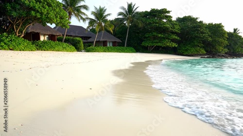 Beautiful Tropical Beach Resort with White Sand and Turquoise Ocean Waves.