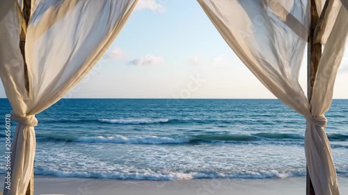 Beautiful tropical beach view from a luxurious curtained gazebo at sunset.