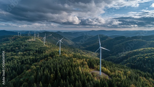 Wind Turbines on a Lush Green Hillside Under a Dramatic Sky.