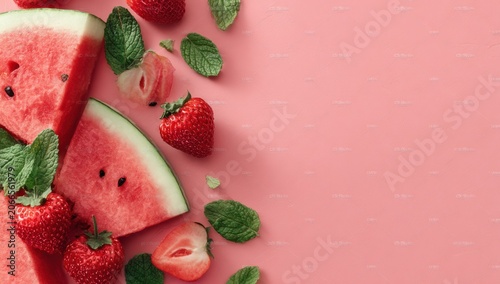 Fresh Summer Fruits Arrangement with Watermelon and Strawberries on Pink Background.
