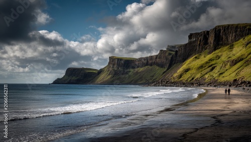 Dramatic Coastal Cliffs Meet Sandy Beach Under Moody Sky.