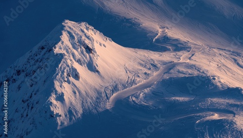 Majestic Snow-Capped Mountain Peak Bathed in Golden Hour Light.