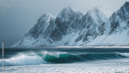 Dramatic Snow-Capped Mountains Meet Crashing Ocean Waves.