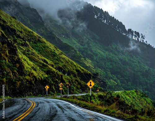 Misty Mountain Road Curving Through Lush Green Hillside Landscape
