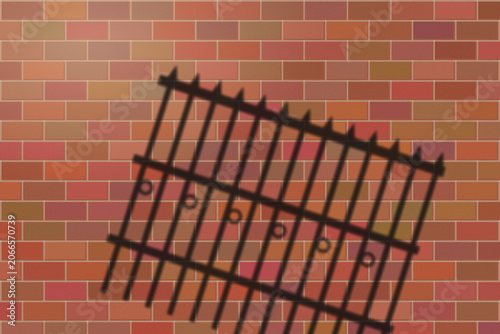 Illuminated Shadows of the City – Iron Fence Shadow on Brick Wall