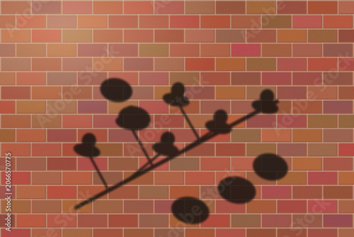 Illuminated Shadows of the City – Leaf Silhouette on Brick Wall