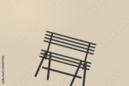 Illuminated Shadows of the City – Park Bench Shadow on Textured Wall