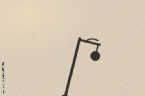 Illuminated Shadows of the City – Street Lamp Shadow on Textured Wall