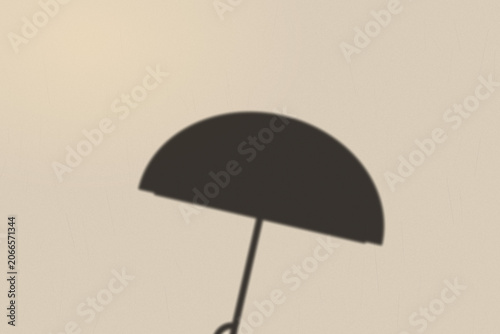 Illuminated Shadows of the City – Umbrella Shadow on Textured Wall