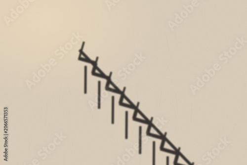 Illuminated Shadows of the City – Staircase Shadow on Textured Wall