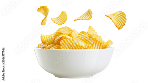 Fotografie Ruffled potato chips in white bowl with flying chips