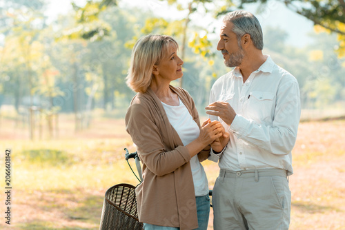 Active happy and enjoy love seniors couple embracing in park