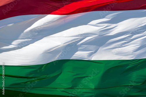 Hungarian flag waving in the wind during a sunny day at a public event in Hungary