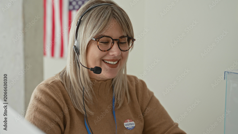 Naklejka premium Woman speaking into headset, wearing glasses and 'voted' sticker at a polling station building; civic pride.