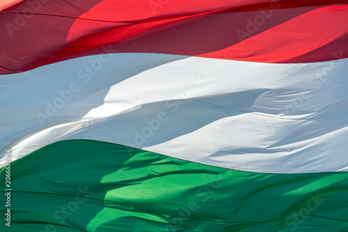 Hungarian flag waving in the wind at a public event showing national pride and colors of the republic