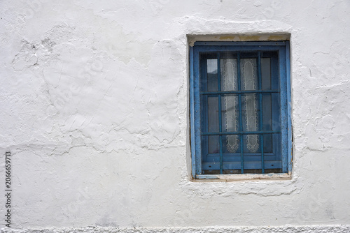 blue window on a traditional Andalusian white wall
