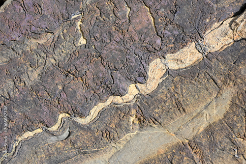 Close-up of a folded mineral vein cutting through weathered alpine rock in the Uri Alps, switzerland