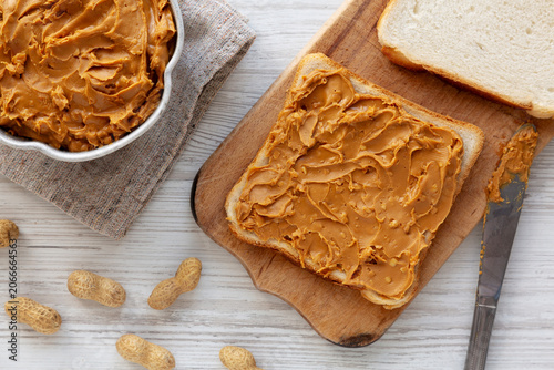 Crunchy Peanut Butter in a Bowl with Bread, top view.