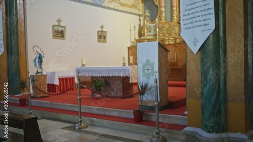 Принти на полотні Church interior with soft defocused altar and red carpeted chancel, shallow blur on columns and ropes; background backplate copyspace calm