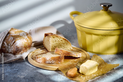 Sliced rustic sourdough bread showing airy crumb texture on wooden board