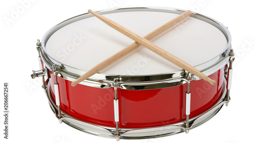 Red snare drum with crossed wooden drumsticks on white