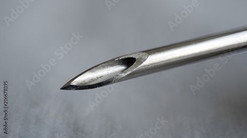 Close-up of surgical needle tip, sterile medical equipment, sharp metal instrument