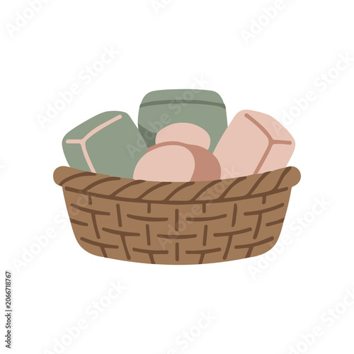 Obraz na plátne Brown wicker basket filled with soap.