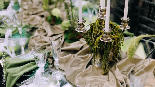 There are various decorations, candles and other decor on the table at the event.