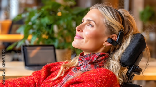 Young woman wearing headphones and red plaid shirt relaxes at home office workspace with laptop and potted plants, listening to music or podcasts during work break.