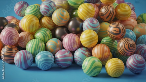 Pile of colorful round balls with swirling vibrant patterns scattered on smooth blue surface playful abstract childhood candy concept