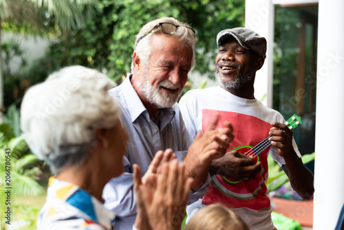 Photos Joyful seniors enjoying music outdoors.