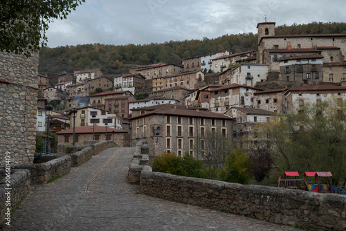 Traditional stone village of Villoslada de Cameros with the Nuestra Señora del Sagrario Church dominating the hillside. Historic rural architecture in La Rioja, northern Spain