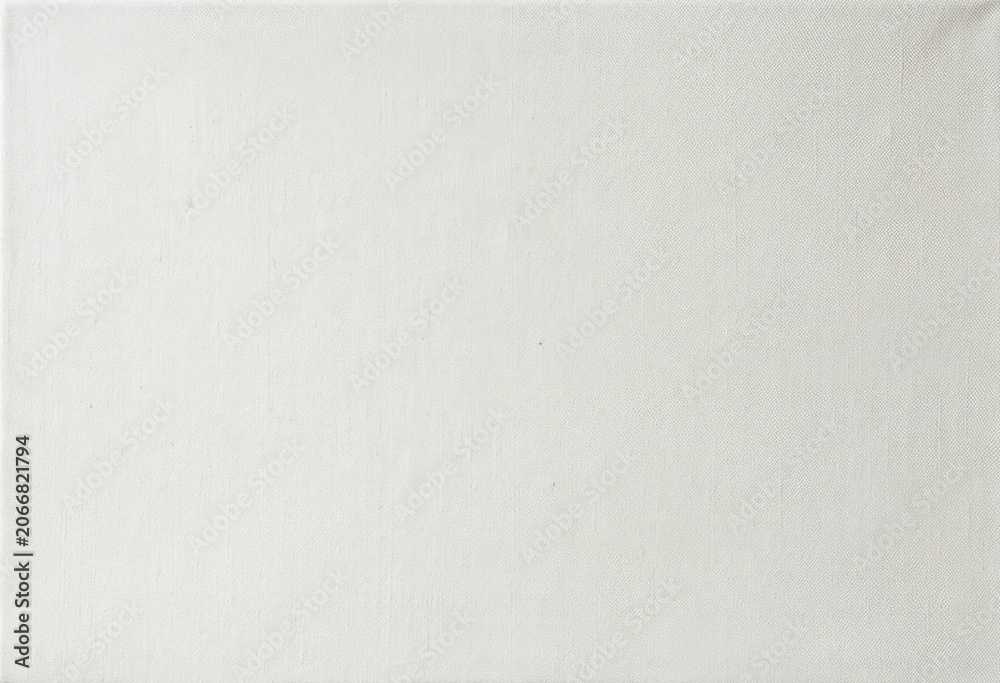 Fototapeta premium A plain, off-white canvas is presented. The texture of the fabric is visible, with subtle variations in tone and a slightly rough surface.
